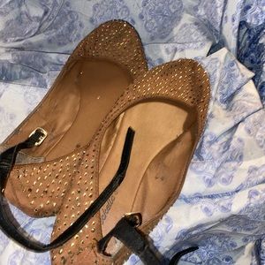 A brown bedazzled shoe